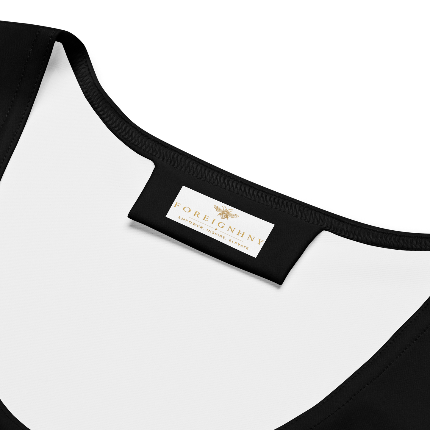 Close-up of a black and white garment with a visible brand label on a white background