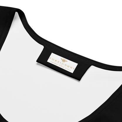 Close-up of a black and white garment with a visible brand label on a white background