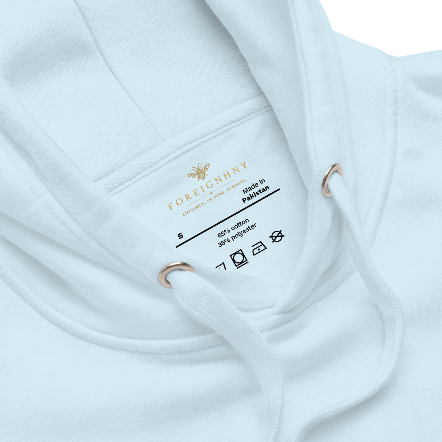 Close-up of a white garment with a label on a white background
