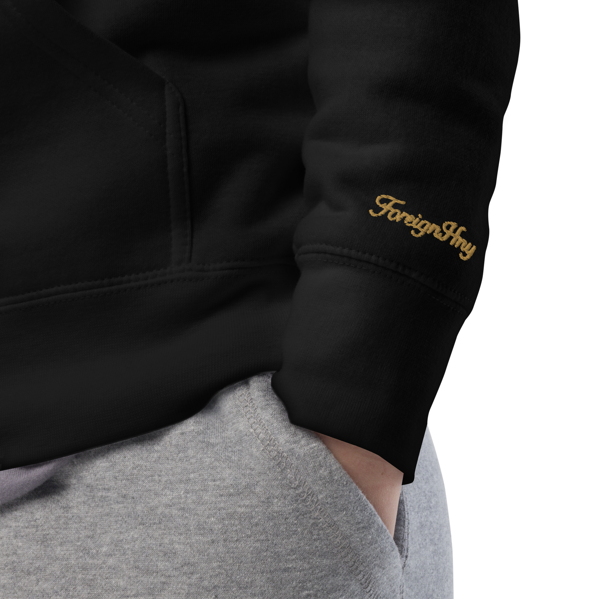 Black hoodie with 'Foreigner' logo on sleeve against a white background