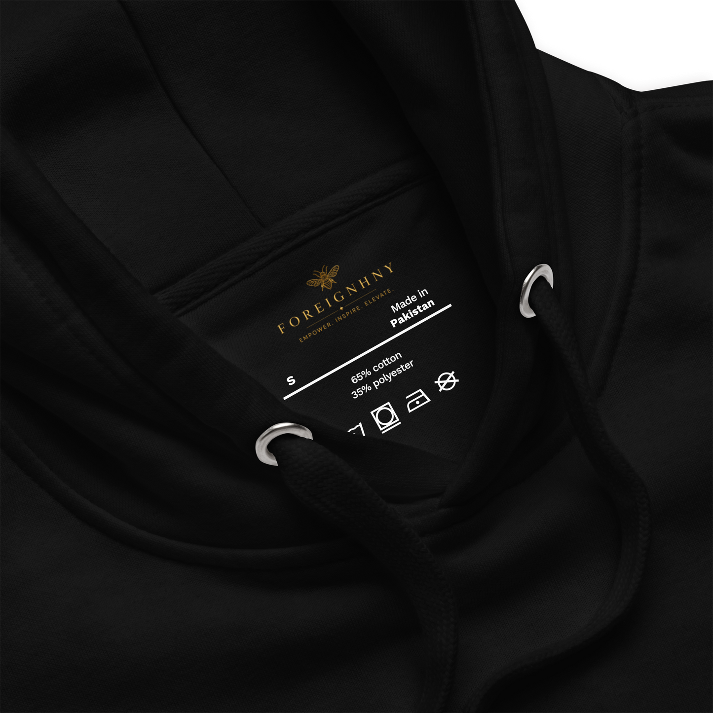 Close-up of a black garment label with brand name and details.