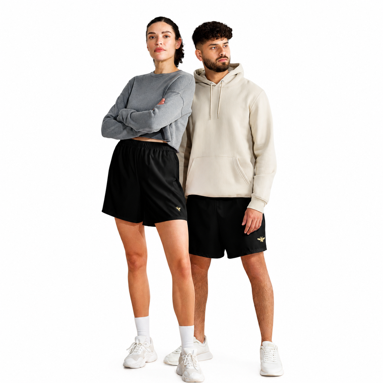 Two people wearing matching athletic outfits with a brand logo on a white background
