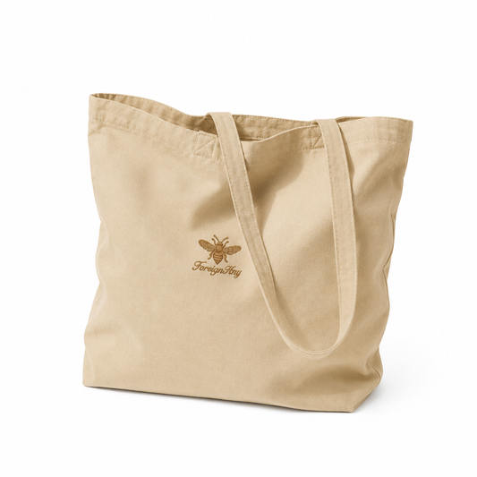 Beige tote bag with a logo on a white background